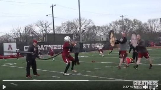 Temple's innovative practice props include a giant face cut-out of HC Geoff Collins