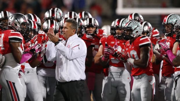 Ohio State Buckeyes head coach Urban Meyer leads the team in pre-game warmup drills prior to the NCAA football game against Penn State at Ohio Stadium in Columbus on Oct. 26, 2013. (Adam Cairns / The Columbus Dispatch)