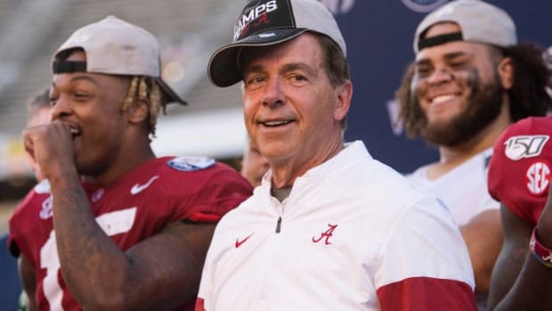 Alabama head coach Nick Saban dons his Champs cap as Alabama defensive back Xavier McKinney (15) and offensive lineman Jedrick Wills, Jr., (74) look on after defeating Michigan in the Citrus Bowl in Orlando, Fla., on Wednesday January 1, 2020. Sabanc01
