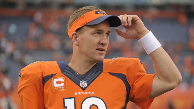Denver Broncos quarterback Peyton Manning (18) watches play from the sidelines late in the fourth quarter against the Philadelphia Eagles in an NFL football game, Sunday, Sept. 29, 2013, in Denver. Denver won 52-20. (AP Photo/Jack Dempsey)