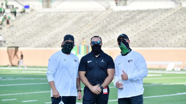 North Texas GAs Quinn Shanbour (middle) and Dane Evans (right) before a recent game. (Credit: North Texas Athletics)