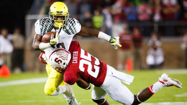 Stanford sophomore cornerback Alex Carter (25) wraps up Oregon sophomore running back Byron Marshall (9) and tackles him to the ground. The No. 3 Oregon Ducks play the No. 5 Stanford Cardinal at Stanford Stadium in Stanford, Calif. on Nov. 7, 2013. (Taylor Wilder/Emerald)