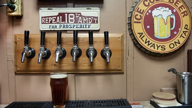 Ken Terry has six tap handles mounted to his basement wall. Each tap is hooked up to a keg of one of his beers on the other side of the wall.
