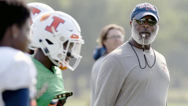 In this Aug. 14, 2018, photo Illinois head football coach Lovie Smith watches his players during training camp at the Campus Rec Fields in Urbana, Ill. A year's worth of experience, intensive strength training and an emerging leader at quarterback could combine to give Illinois a realistic shot at playing some winning football. (Stephen Haas/The News-Gazette via AP) ORG XMIT: ILCHN502