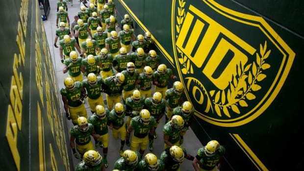 The Oregon Ducks make their way to the field with new yellow helmets before their season opener against Arkansas State at Autzen Stadium September 1, 2012. (Alex McDougall/The Emerald)