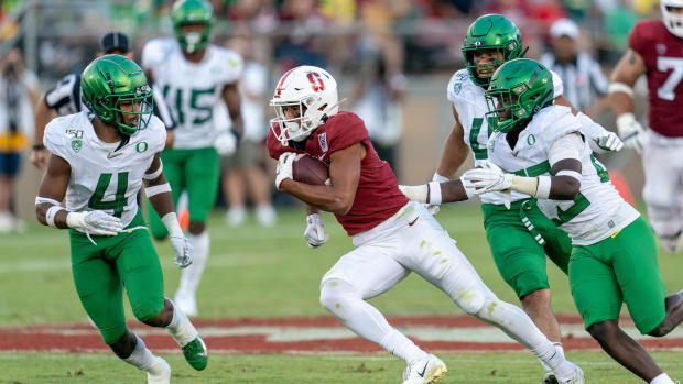 Sep 21, 2019; Stanford, CA, USA; Stanford Cardinal wide receiver Michael Wilson (4) runs for the first down during the fourth quarter against Oregon Ducks cornerback Thomas Graham Jr. (4) at Stanford Stadium. Mandatory Credit: Neville E. Guard-USA TODAY Sports