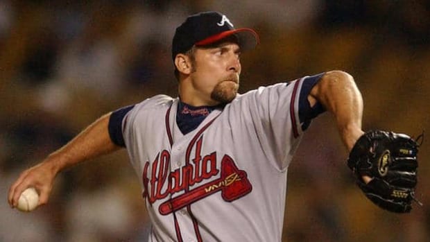 LOS ANGELES, UNITED STATES:  (FILES) This 25 August, 2002, file photo shows Atlanta Braves pitcher John Smoltz in action against the Los Angeles Dodgers in Los Angeles. Smoltz, a key figure in Atlanta's run of 13 straight division titles, will be a Brave for at least two more years, the club said 16 December, 2004. The Braves signed Smoltz to a two-year contract with a club option for 2007. Financial terms were not disclosed.   AFP PHOTO/Lucy NICHOLSON/FILES  (Photo credit should read LUCY NICHOLSON/AFP/Getty Images)