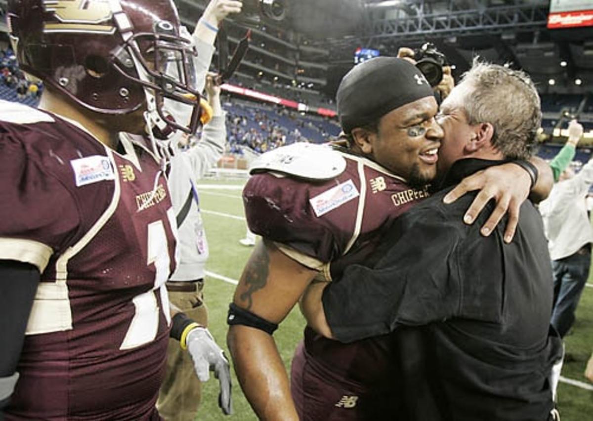 (CAPTION INFORMATION) Interim head coach Jeff Quinn, right, hugs linebacker Red Keith as they celebrate their win 31-14 victory as Central Michigan University takes on Middle Tennessee State University in the MotorCity Bowl at Ford Field, Mich. on December 26, 2006.    (Robin Buckson / The Detroit News)