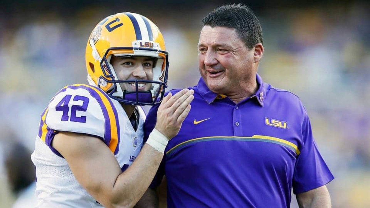 Former LSU head football coach, Ed Orgeron, right, talks to his girlfriend  Bailie Lauderdale during the third quarter of an NCAA college football game  between Texas A&M and Miami on Saturday, Sept.