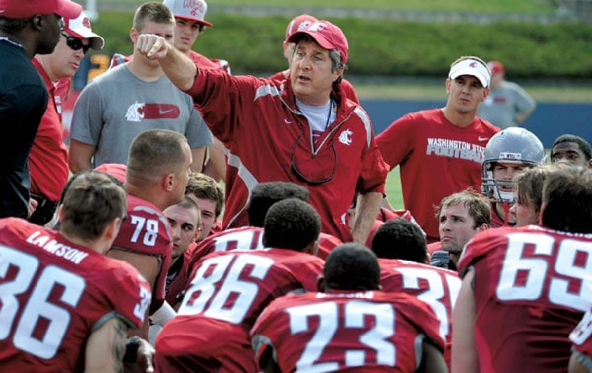 Washington State University head football coach, Mike Leach, talks with his players during the WSU Crimson and Gray Football Game, Saturday, April 21, 2012 in Spokane, Wash.  (AP Photo/Dan Pelle)