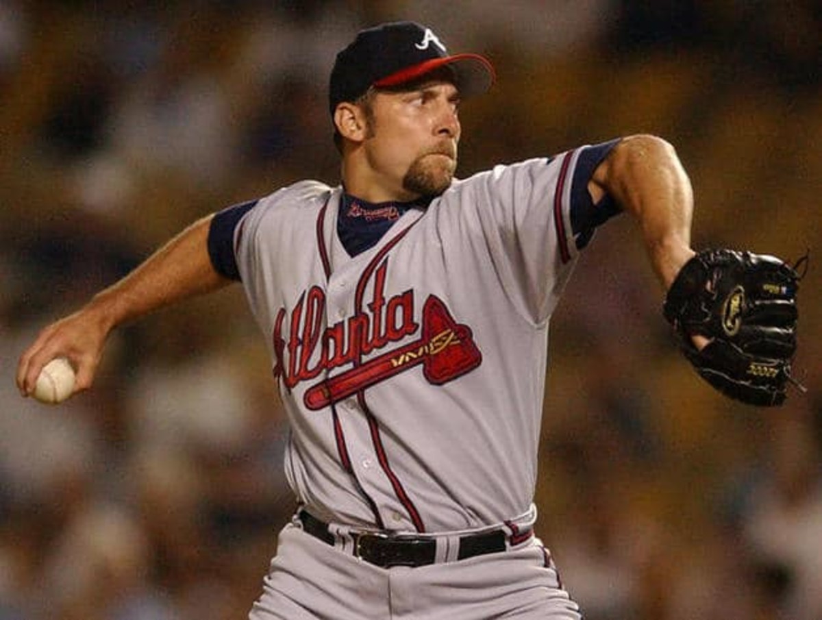 LOS ANGELES, UNITED STATES:  (FILES) This 25 August, 2002, file photo shows Atlanta Braves pitcher John Smoltz in action against the Los Angeles Dodgers in Los Angeles. Smoltz, a key figure in Atlanta's run of 13 straight division titles, will be a Brave for at least two more years, the club said 16 December, 2004. The Braves signed Smoltz to a two-year contract with a club option for 2007. Financial terms were not disclosed.   AFP PHOTO/Lucy NICHOLSON/FILES  (Photo credit should read LUCY NICHOLSON/AFP/Getty Images)
