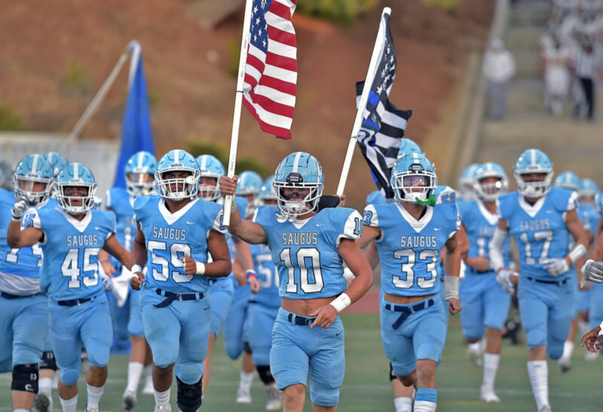 California school system halts football team carrying police flag