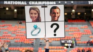 Auburn staffer proposes before game using sideline play sign (Auburn)