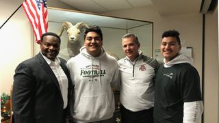 Video: Urban Meyer and Larry Johnson jump out of their seats to celebrate a commitment in a recruit's living room (recruiting)